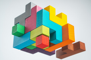 Naklejka premium Abstract construction from wooden blocks. The concept of logical thinking..