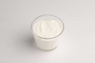 sour cream in a transparent bowl, white sour cream, on a white background, isolated