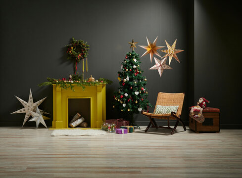 Christmas new year style in the grey room with yellow fireplace, chair gift box and ornament decoration.