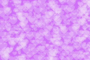 Abstract background - a bokeh of white hearts on a purple background.