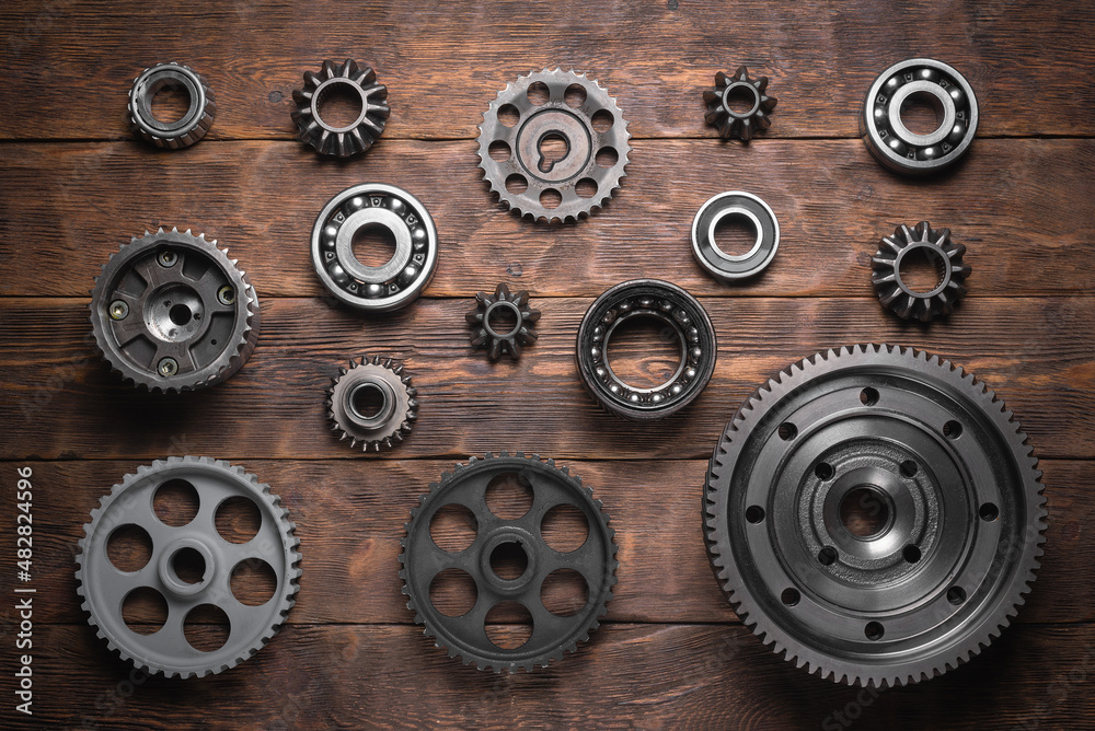 Wall mural Various car cogwheels and bearings flat lay background.