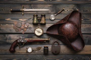 Pirate equipment and accessories on the flat lay table background.