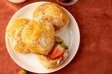 Malasada sprinkled with sugar top view. Free space.