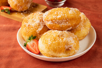 Sweet Portuguese donuts in sugar. Malasada.