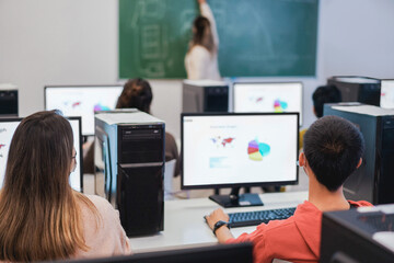 Multiracial students using computers during business class wearing safety masks at school - Focus on right boy head