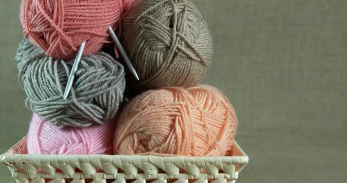 Collection of yarn balls. A big collection of woolen yarn balls on the plate in the room.