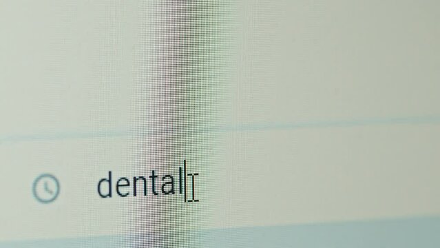Close-up view of computer screen with word dental being typed out in search string