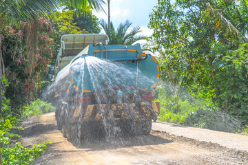 Industrial Water Truck pours the road with water, Dust removal, truck working at a construction site, new road construction project