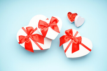 Gift boxes for Valentine's Day on blue background, flat lay.