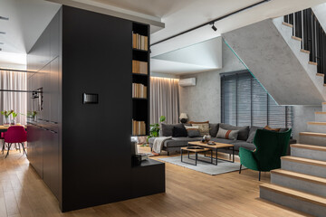 Stylish composition of living room interior with corner grey sofa, green velvet armchair, coffee table, wooden floor,  design furniture and  personal accessories. Modern home decor. Template.