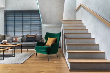 Stylish composition of living room interior with corner grey sofa, green velvet armchair, coffee table, wooden floor,  design furniture and personal accessories. Modern home decor. Template.