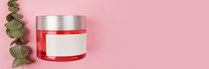 Flat lay with Natural organic cosmetics: serum, cream on pink background with green leaves. Skincare, cosmetology, dermatology concept. Beauty certificate, blog style. Top view, mockup, overhead