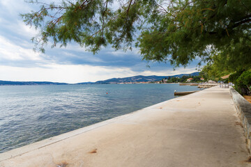 Embankment in Croatia, Kastel Luksic. View of the Adriatic Sea and mountains. In the background is the city of Trogir. Selective focus.