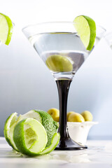 martini lime and olives on a table