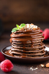Tasty Chocolate Pancakes With Chocolate Hazelnut Sauce Topping. Sweet Breakfast Pancakes Stack