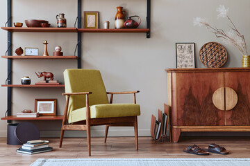 Modern retro concept of living room interior with stylish armchair, wooden shelf, book, picture...