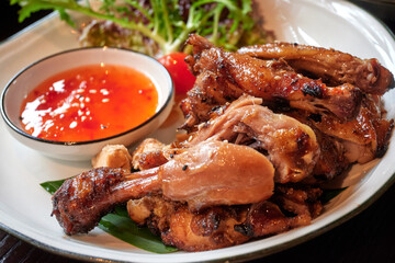 Roasted chicken in Thai style with dip-sauce.