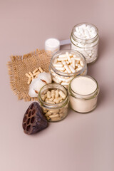 Nutritional supplements in beautiful composition from above in rustic style on light background. Organic food supplements for people. No gluten and lactose free vitamins and minerals. Flat lay food. 