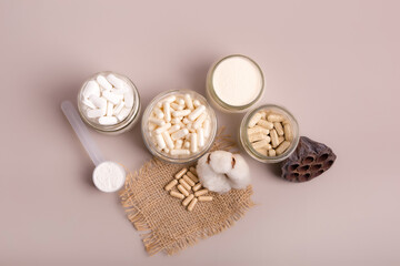 Flat lay view of nutritional supplements and multivitamins for help to support high immune system. Vitamins to avoid illnesses. Top view of vitamins on light neutral background. Pills and medications