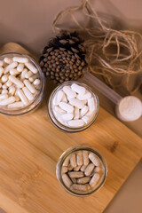 Vitamins and immune health nutrition supplements on wooden desk.