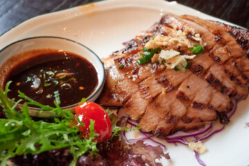 sliced pok neck got grilled and served with spicy dip-sauce.