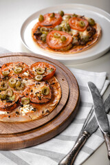 Wheat tortilla with tomatoes, mozzarella cheese and olives. Vertical shot