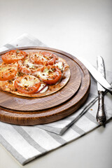 Wheat tortilla with tomatoes, mozzarella cheese and olives. Vertical shot. Copy space