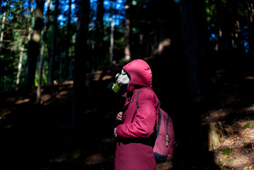 Ecological catastrophy. Post apocalyptic survivor in gas mask. Man at forest.