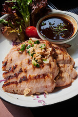 sliced pok neck got grilled and served with spicy dip-sauce.