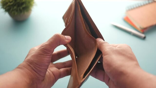 Man hand open an empty wallet with copy space.