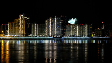 Fototapeta na wymiar Lights of the night city by the river