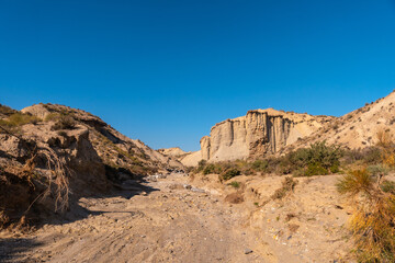Fototapeta na wymiar Tabernas desert trail, Almería province, Andalusia. On a trek in the Rambla del Infierno