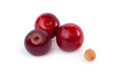 Studio shot of three cherry plums with pit