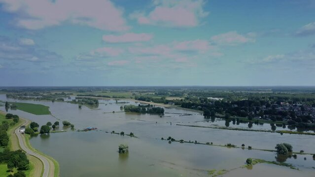 High water level on the floodplains of the river IJssel near the city of Zwolle in Overijssel during summer after heavy rainfall upstream. Aerial drone point of view.