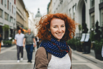 Portrait shot of beautiful ginger woman tourist smiling in the city in front od St. Stephen...