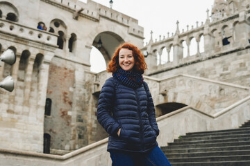 Fototapeta na wymiar Young woman with ginger hair in the Fisherman's Bastion in the Castle district of Budapest