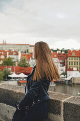 Fototapeta na wymiar Woman on view point with amazing view. Cute female tourist in Prague, Czech republic.