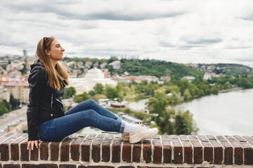 Fototapeta na wymiar Woman on view point with amazing view. Cute female tourist in Prague, Czech republic.