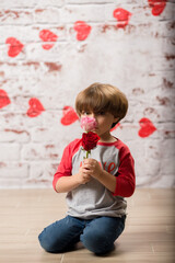 Fototapeta premium Boy small child posing for kisses for valentines day charging cute kid making faces being sweet. 