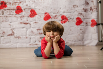 Boy small child posing for kisses for valentines day charging cute kid making faces being sweet. 