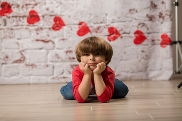 Fototapeta premium Boy small child posing for kisses for valentines day charging cute kid making faces being sweet. 