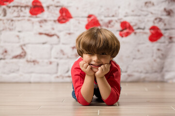 Boy small child posing for kisses for valentines day charging cute kid making faces being sweet. 