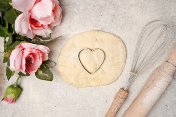 Valentine day baking background. Ingredients for cooking and Valentine's heart in dough. Top view
