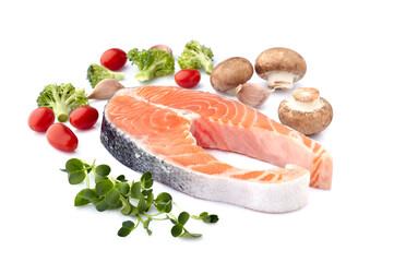 Salmon fish on the white background with fresh  vegetables.  Salmon steak isolated.