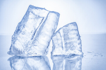 Frozen icicle pieces close up on blue background