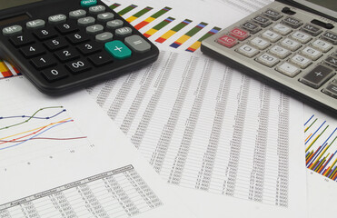 Business concept, calculators on financial data charts and graphs.	