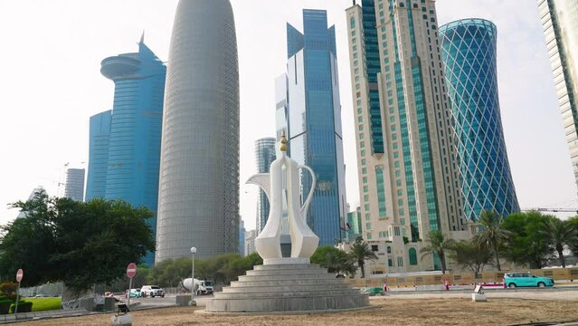 The Dallah Coffee Pot monument at Doha seen from Park. Mordern skyscrapers and towers on background
