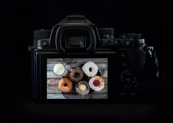 Image of donuts and a glass of milk top view in a lcd Screen on a DSLR or Mirrorless camera with...