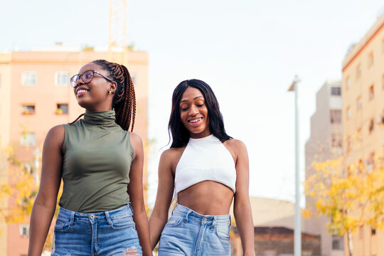 couple of black girls strolling happy in the city