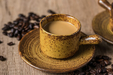 hot coffee in brown cup on wooden background